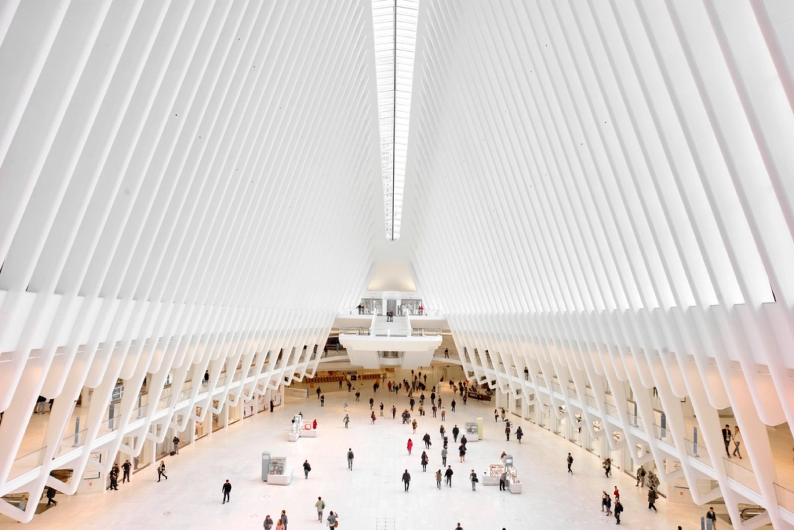 A large, bright public concourse with people walking across it